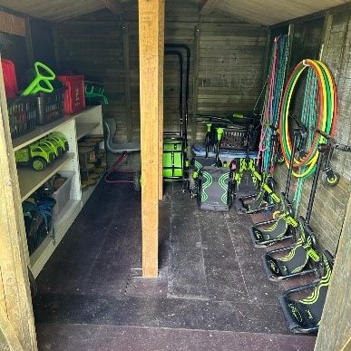 Aufgeräumter Geräteschuppen mit Werkzeugen, Spielzeug und Sportgeräten.
